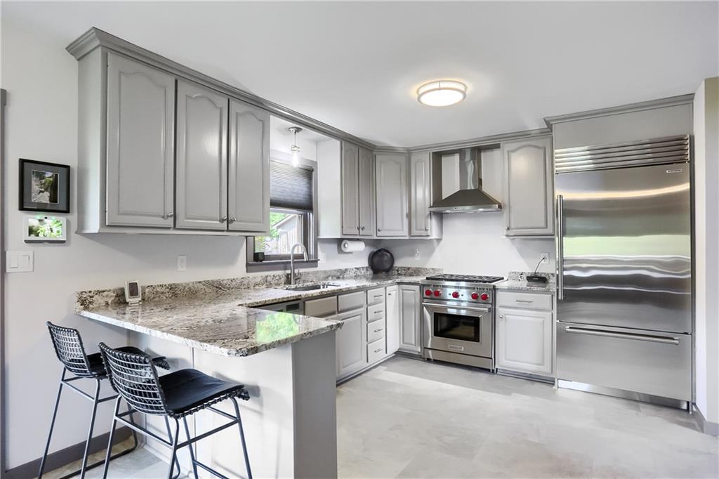 595 Trusel Road Portersville, PA 16051 - Photo 13 of 48 a kitchen with stainless steel appliances granite countertop a stove and a refrigerator