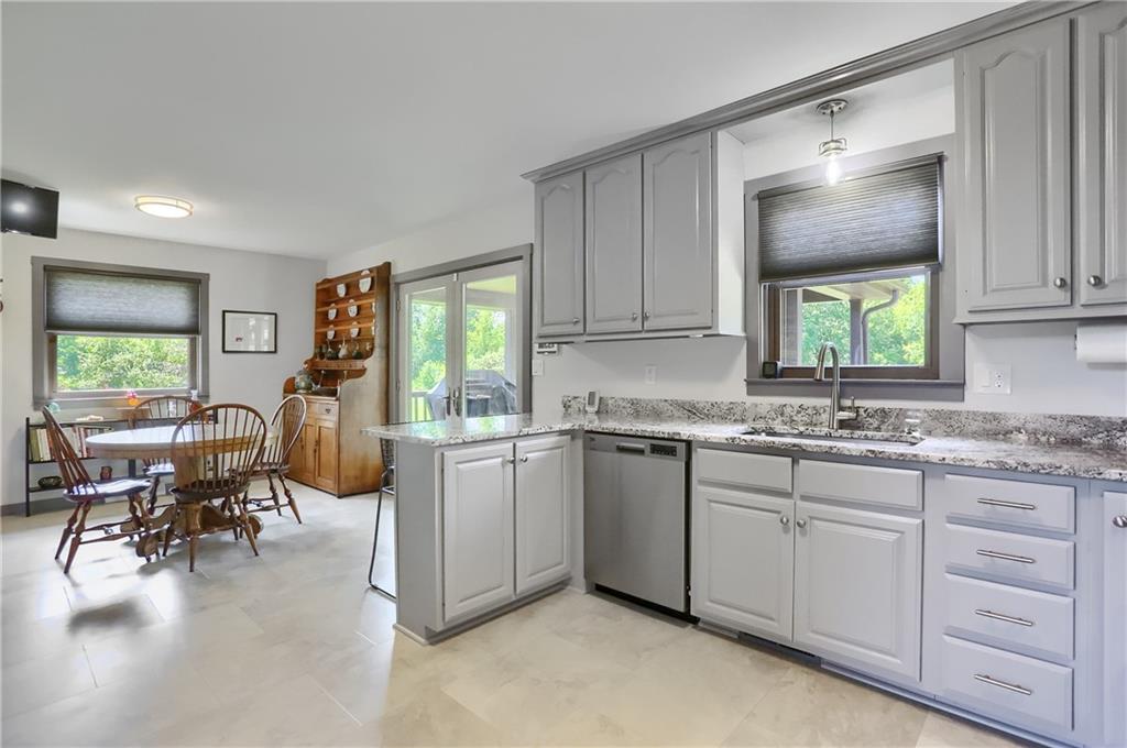 595 Trusel Road Portersville, PA 16051 - Photo 20 of 48 a kitchen with sink cabinets and dining table
