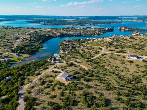an aerial view of a house with a lake view