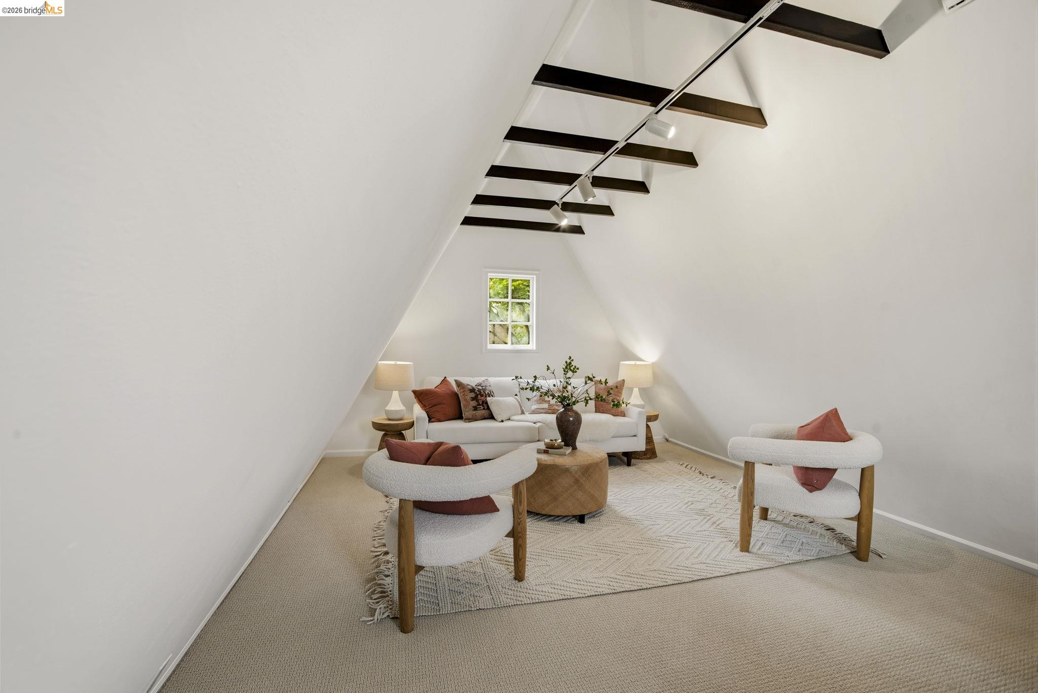 1087 Hubert Road Oakland, CA 94610 - Photo 40 of 67 Sloped ceiling room featuring exposed dark wood beams and track lighting