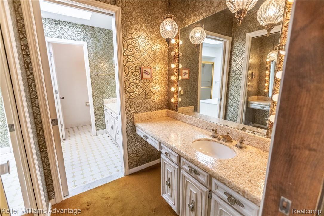16724 Farmington Road Livonia, MI 48154 - Photo 23 of 57 Master bath vanity. Walk in closet to the left
