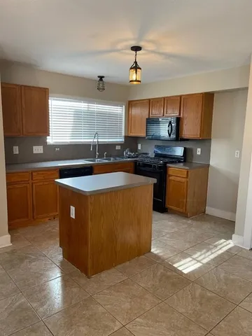 a kitchen with stainless steel appliances granite countertop a sink counter space cabinets and a window