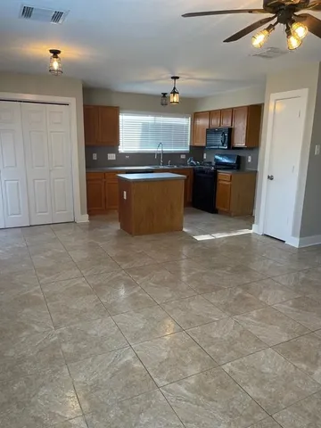 a large kitchen with cabinets and a stove