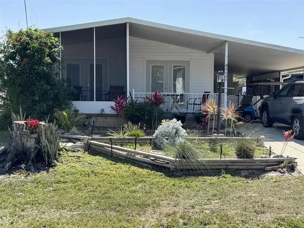 a view of a house with swimming pool and sitting area