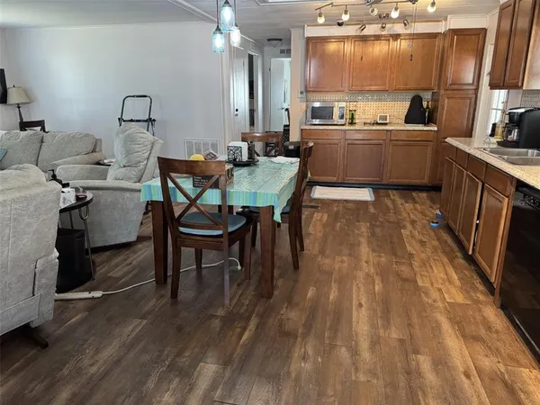 a kitchen with stainless steel appliances granite countertop a stove refrigerator and sink