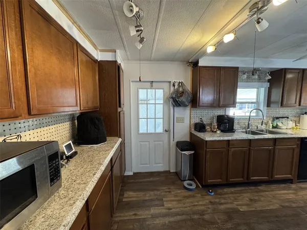 a kitchen with a dining table chairs and refrigerator