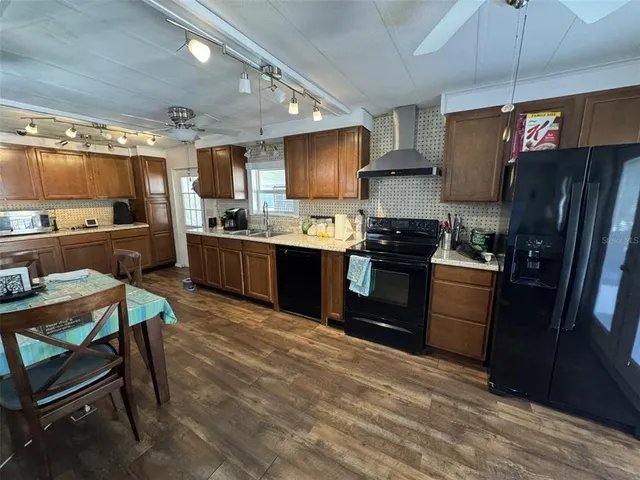 a kitchen with sink cabinets and wooden floor