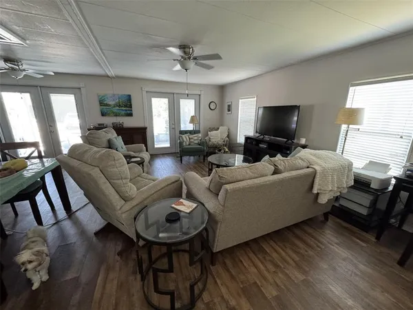 a living room with furniture and a chandelier