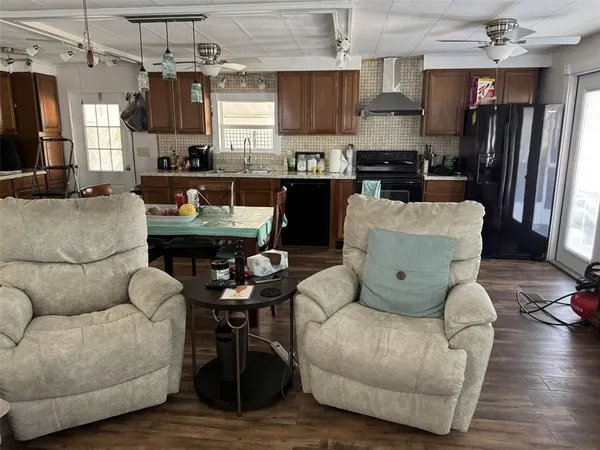 a living room with furniture and kitchen view