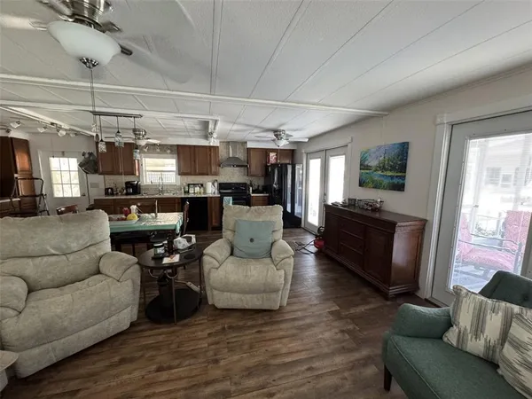 a bedroom with a bed and a flat tv screen on dresser