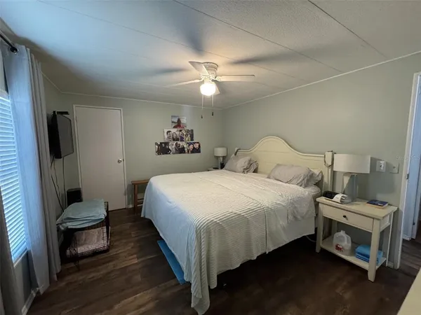a bedroom with a bed and a chandelier