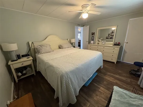 a large bedroom with a bed and a chandelier