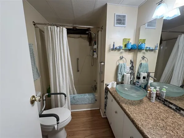 a bedroom with a bed a couch and dresser