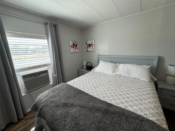 a bedroom with a large bed and a chandelier