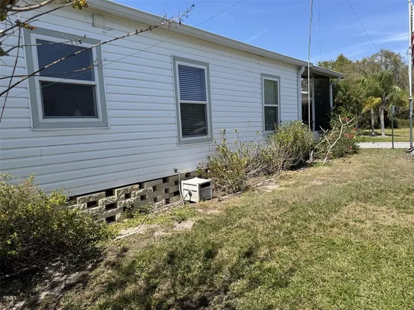a backyard of a house with plants and trees