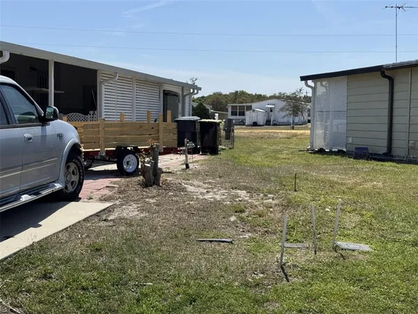 a backyard of a house with barbeque oven table and chairs