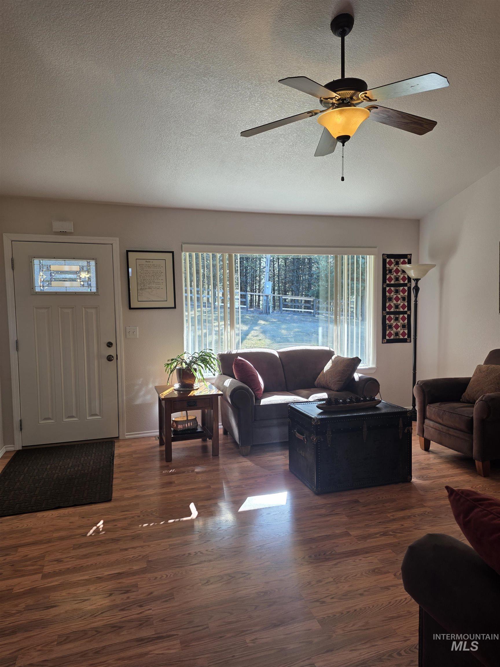 5288 Lakeview Road Orofino, ID 83544 - Photo 12 of 36 Living area featuring dark wood-style floors, a textured ceiling, and a ceiling fan