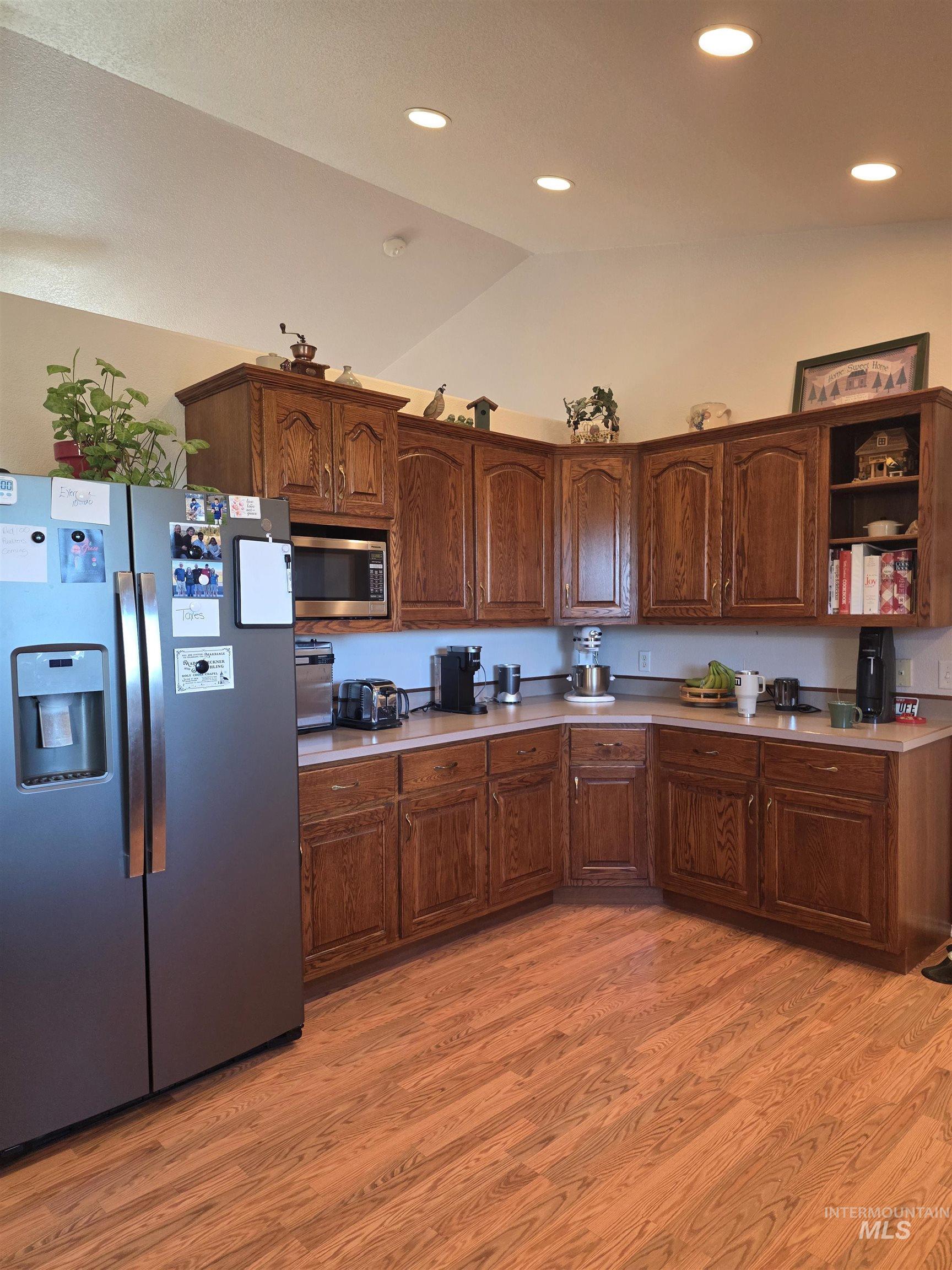 5288 Lakeview Road Orofino, ID 83544 - Photo 17 of 36 Kitchen with stainless steel appliances, lofted ceiling, light countertops, open shelves, and light wood-type flooring