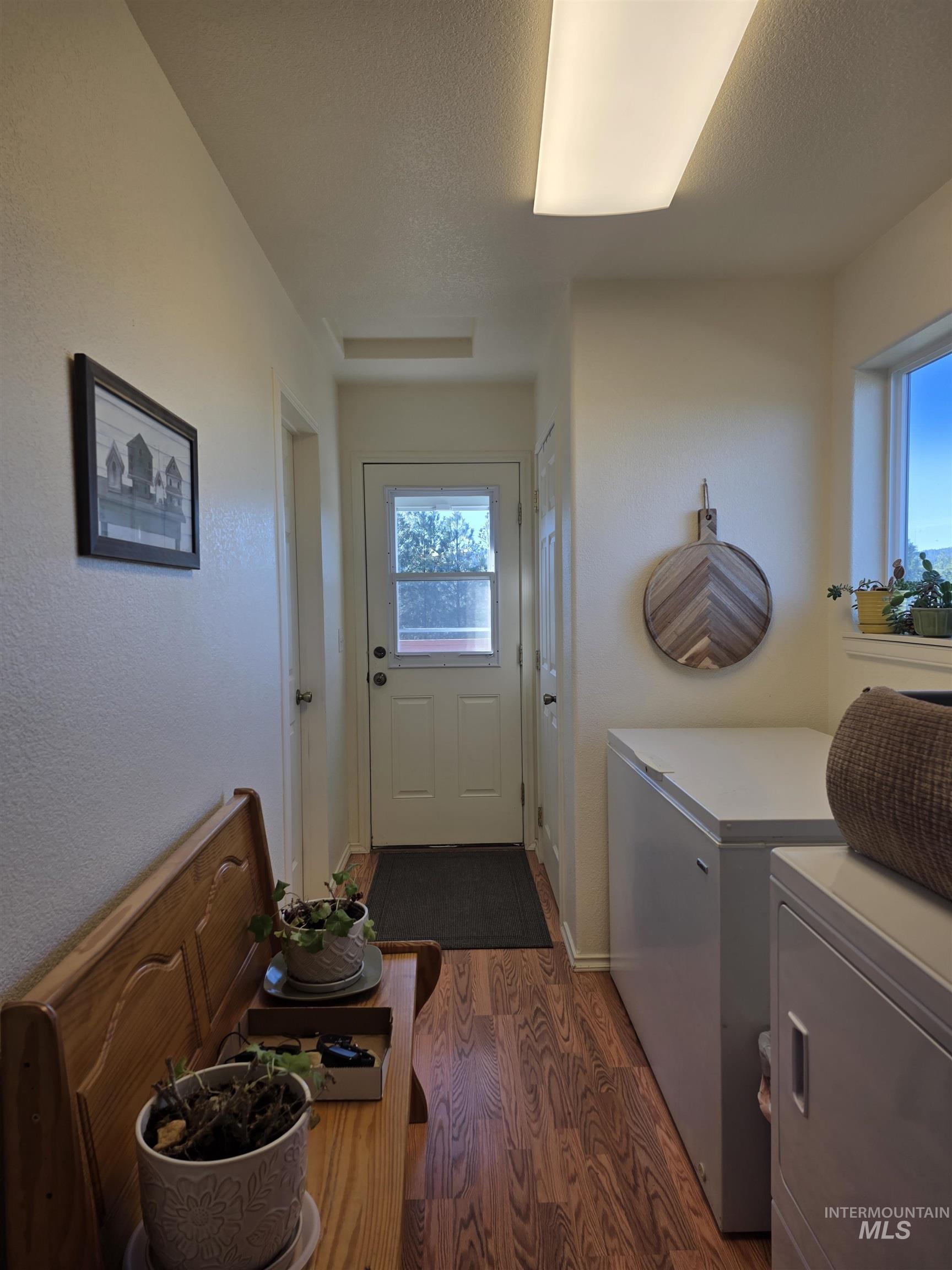 5288 Lakeview Road Orofino, ID 83544 - Photo 24 of 36 Laundry area featuring dark wood-type flooring, a textured ceiling, and washing machine and dryer