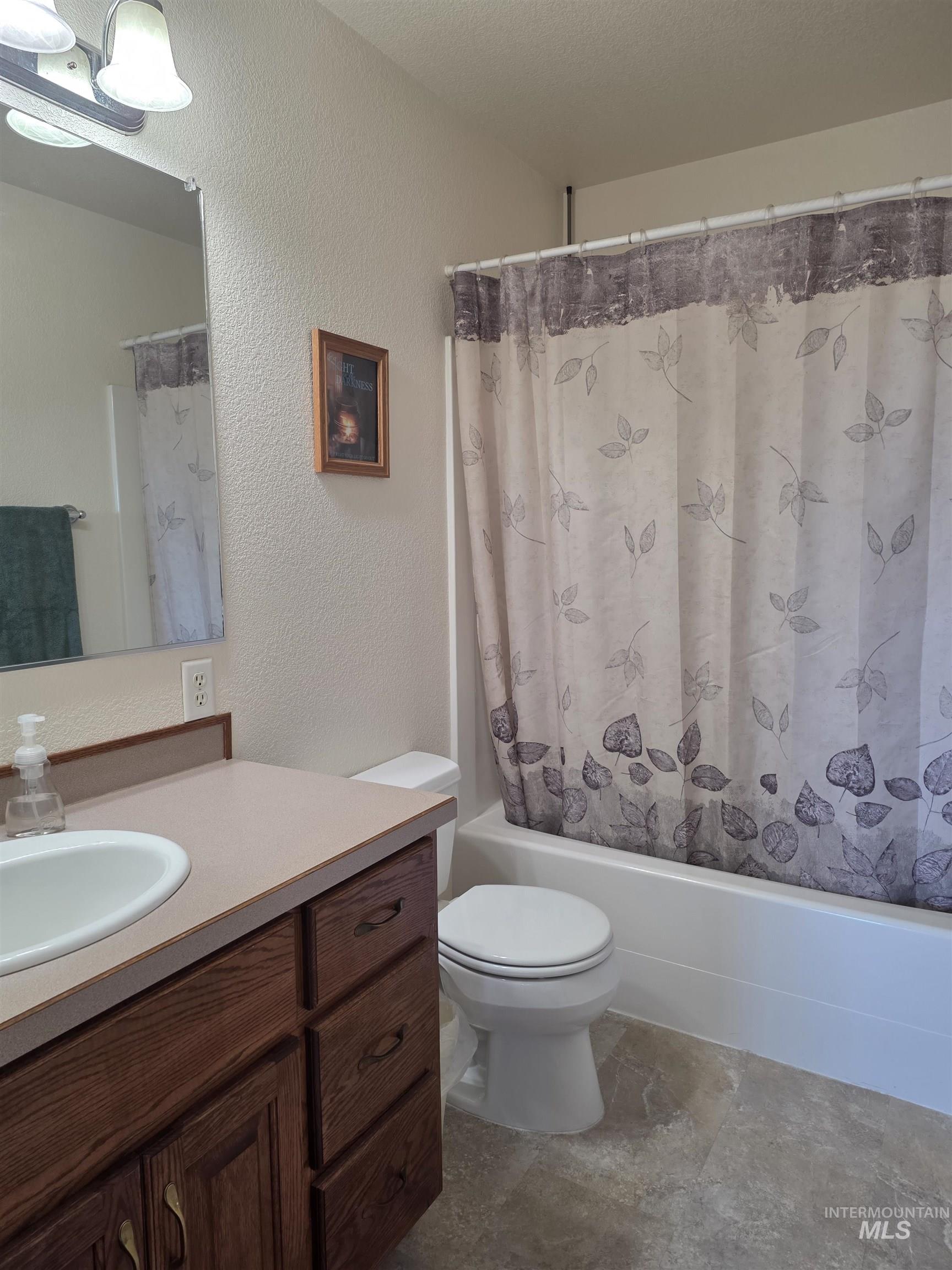 5288 Lakeview Road Orofino, ID 83544 - Photo 27 of 36 Full bath featuring a textured wall, vanity, and shower / bath combo with shower curtain
