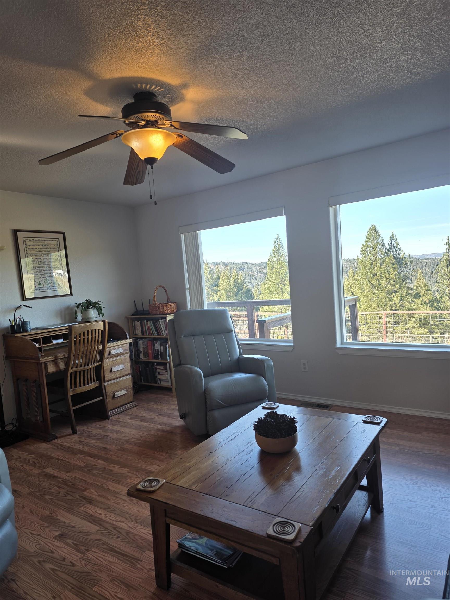 5288 Lakeview Road Orofino, ID 83544 - Photo 33 of 36 Living room with a textured ceiling, dark wood-style floors, and a ceiling fan