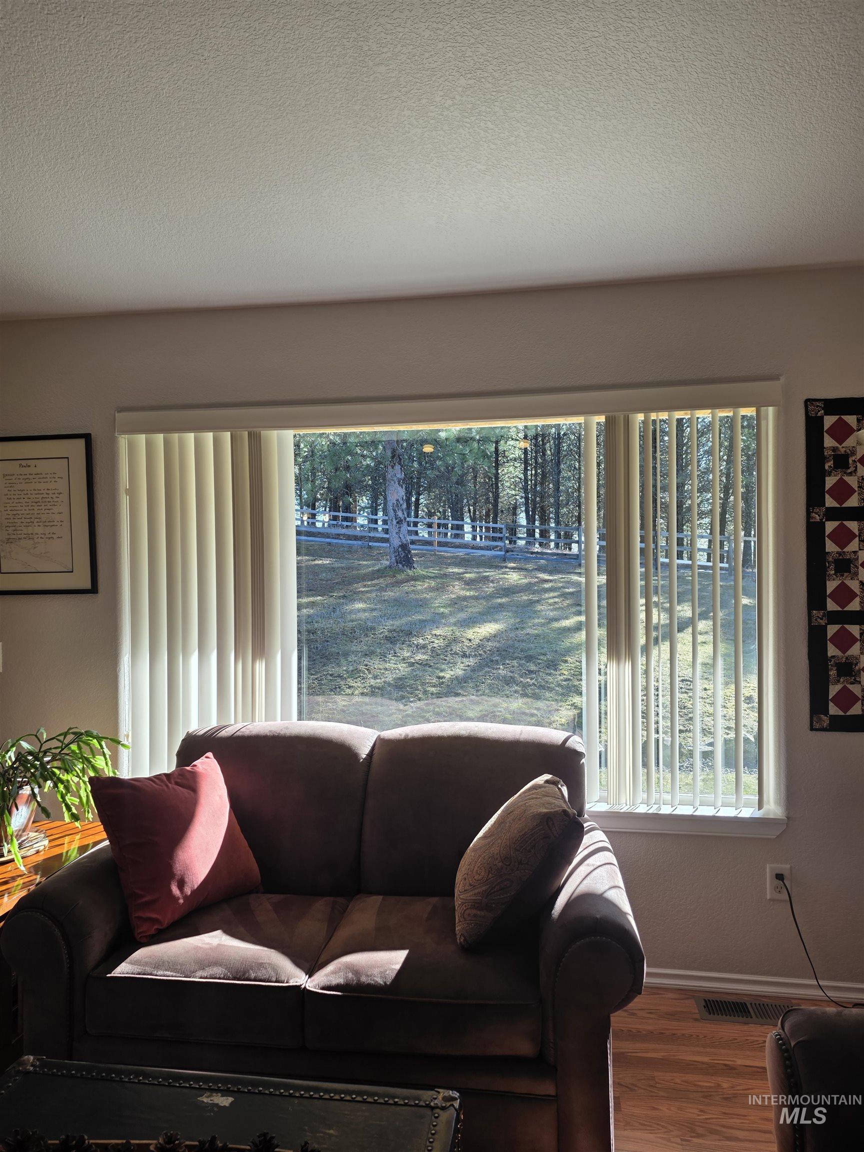 5288 Lakeview Road Orofino, ID 83544 - Photo 10 of 36 Living room featuring a textured ceiling and wood finished floors