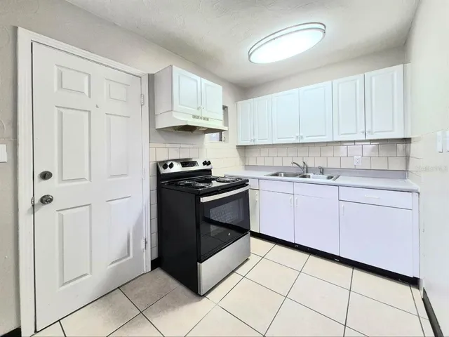 a kitchen with cabinets and appliances