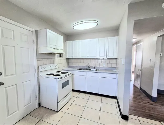 a kitchen with granite countertop cabinets and steel stainless steel appliances