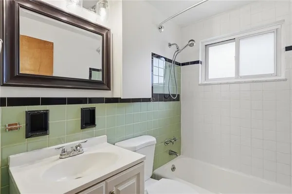 a bathroom with a toilet and a bathtub