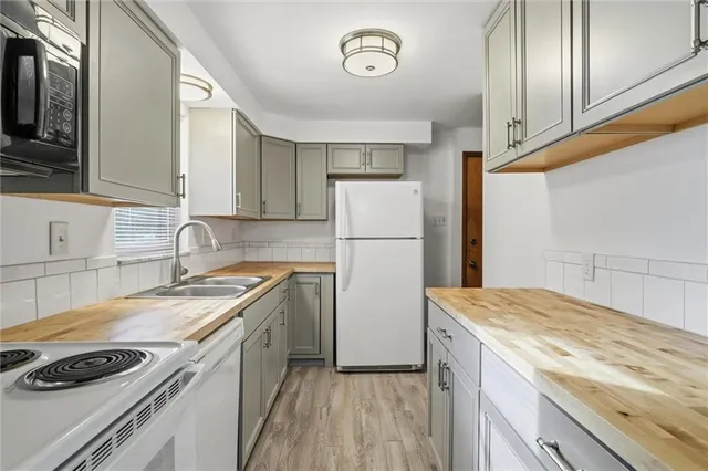 a kitchen with a sink a stove and cabinets
