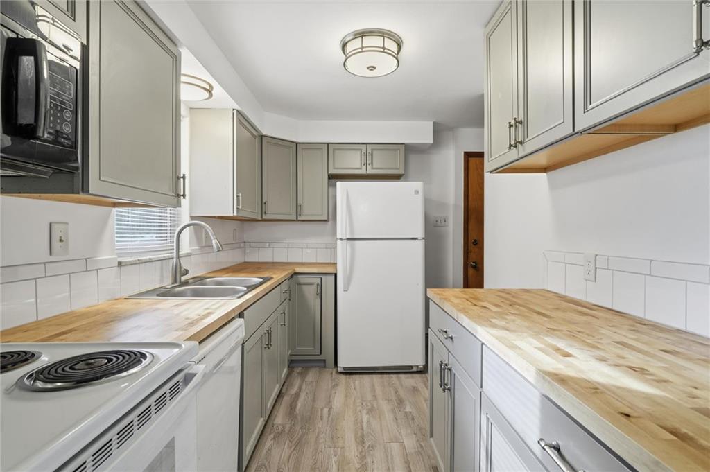2055 Washington Road Pittsburgh, PA 15241 - Photo 20 of 31 a kitchen with a sink a stove and refrigerator