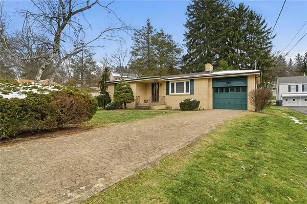 a front view of house with yard and green space