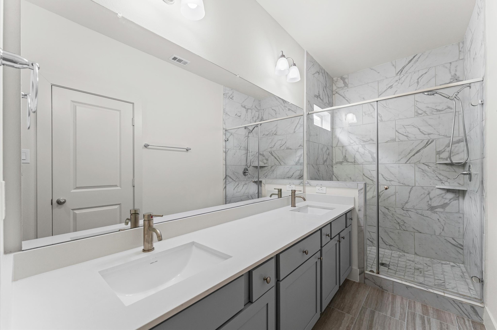 4163 Griggs Road Houston, TX 77021 - Photo 14 of 20 Spacious primary bath features quartz countertops, double sinks, and a walk-in shower.