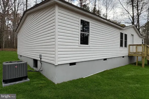 a view of a house with a yard and furniture