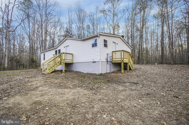 a wooden bench sitting in the middle of a forest