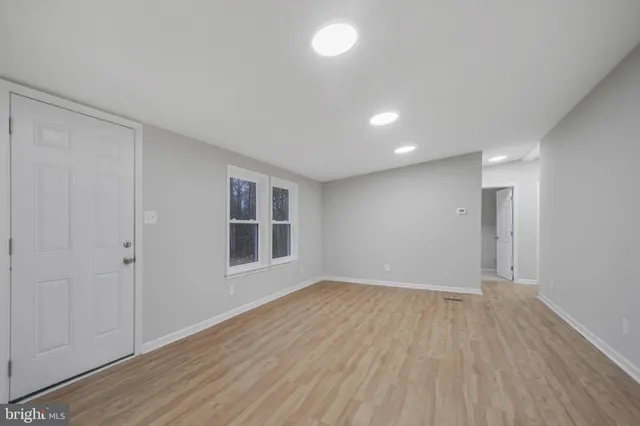 a kitchen with stainless steel appliances a stove a microwave and white cabinets