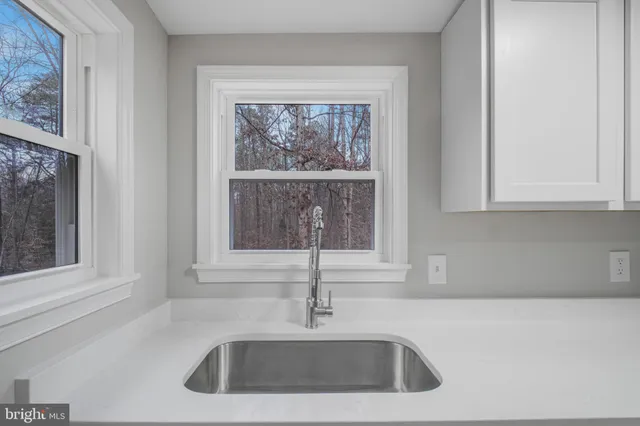 a kitchen with a wooden floor and a sink