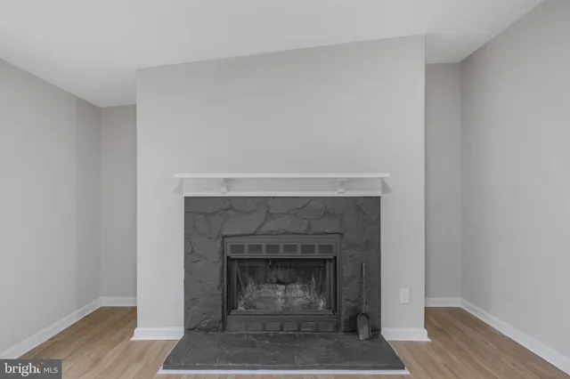 a living room with a fireplace and a wooden floor