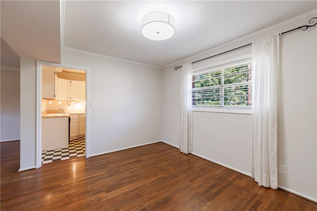3660 Peachtree Road Northeast, Unit H2 Atlanta, GA 30319 - Photo 12 of 55 an empty room with wooden floor and windows