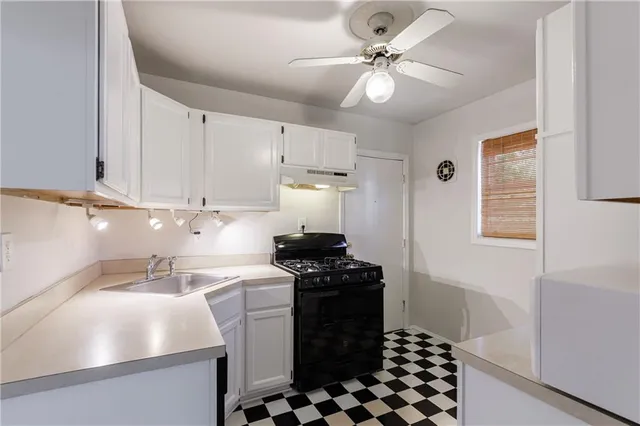 a kitchen with a refrigerator and a stove top oven