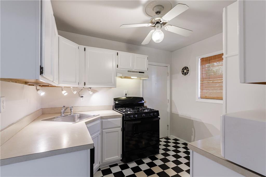 3660 Peachtree Road Northeast, Unit H2 Atlanta, GA 30319 - Photo 13 of 55 a kitchen with a sink a stove and cabinets