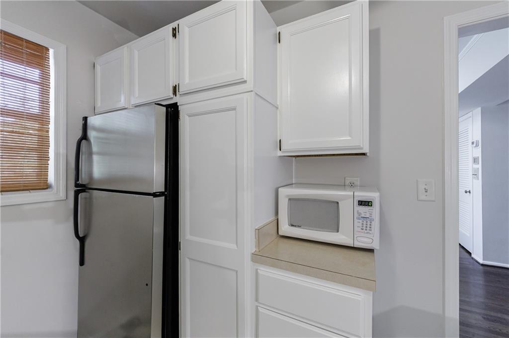 3660 Peachtree Road Northeast, Unit H2 Atlanta, GA 30319 - Photo 17 of 55 a white refrigerator freezer and a stove sitting inside of a kitchen