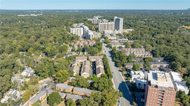 an aerial view of a residential houses with yard