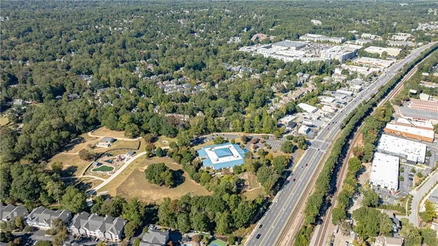 an aerial view of residential house with outdoor space and trees all around