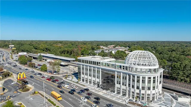 an aerial view of a house with a swimming pool and lake view