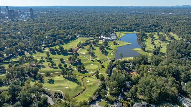 an aerial view of a house with yard swimming pool and outdoor seating