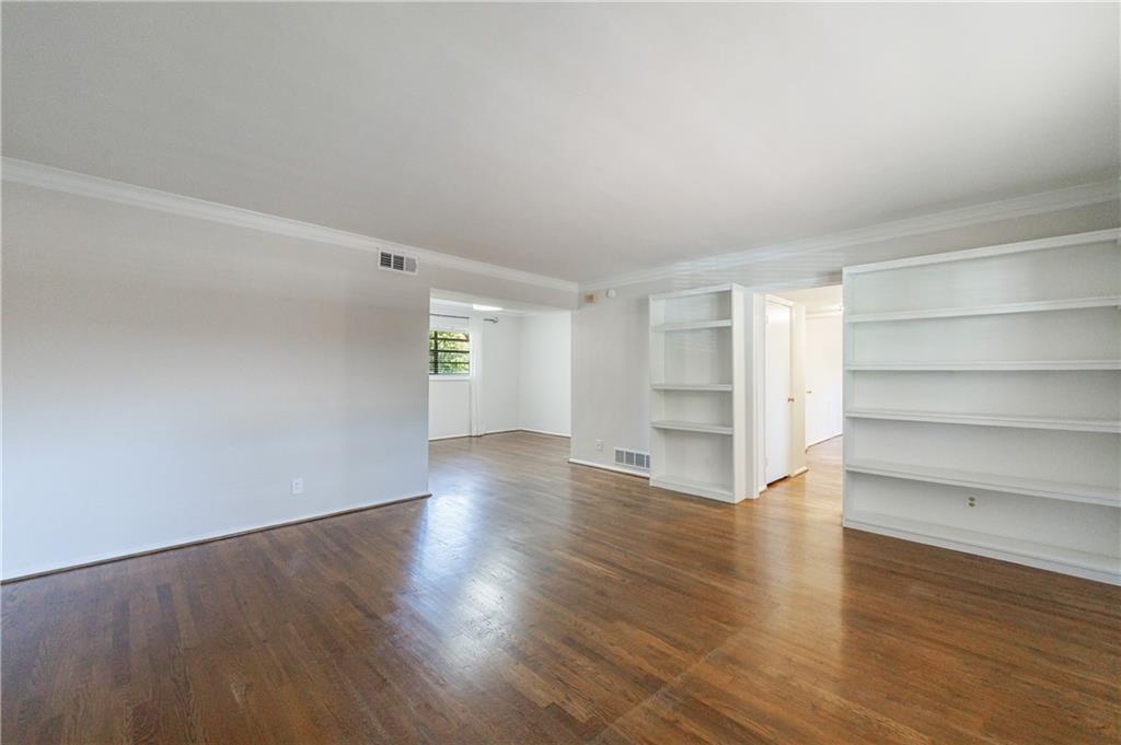 3660 Peachtree Road Northeast, Unit H2 Atlanta, GA 30319 - Photo 6 of 55 a view of an empty room with wooden floor and closet