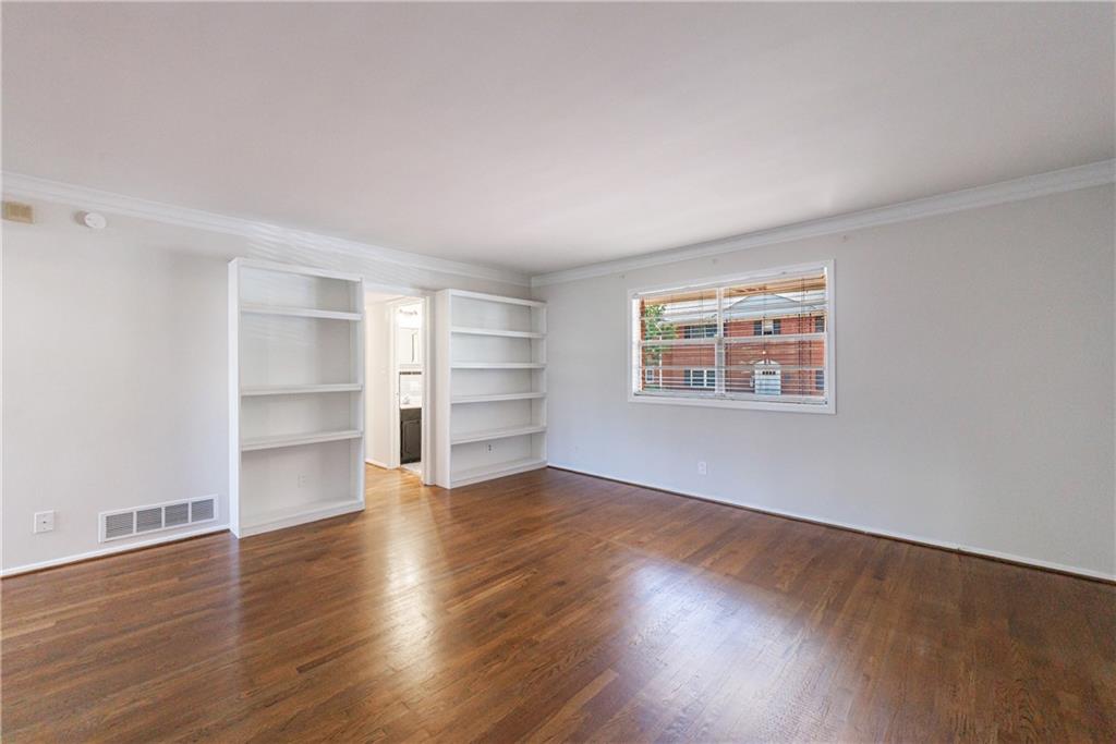 3660 Peachtree Road Northeast, Unit H2 Atlanta, GA 30319 - Photo 8 of 55 a view of an empty room with a window and wooden floor