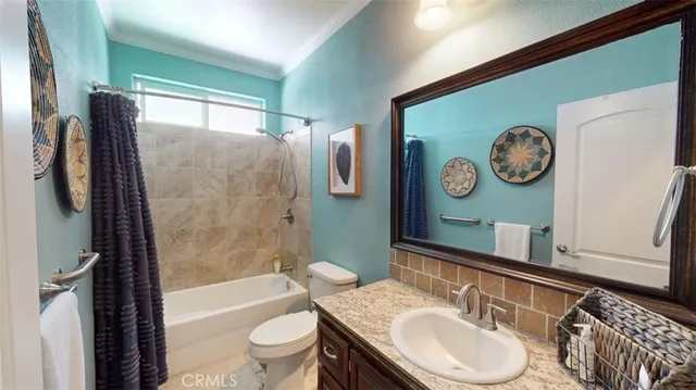 a bathroom with a granite countertop shower and a sink