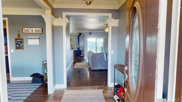 a view of a hallway with entryway and livingroom